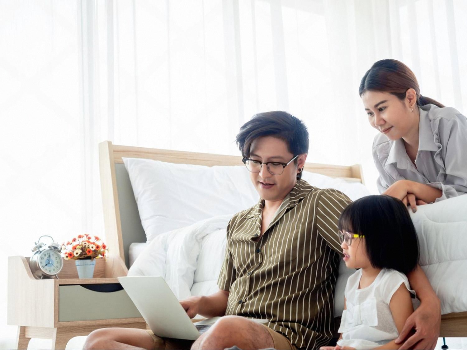Family looking at a laptop while researching a domain name for a new website
